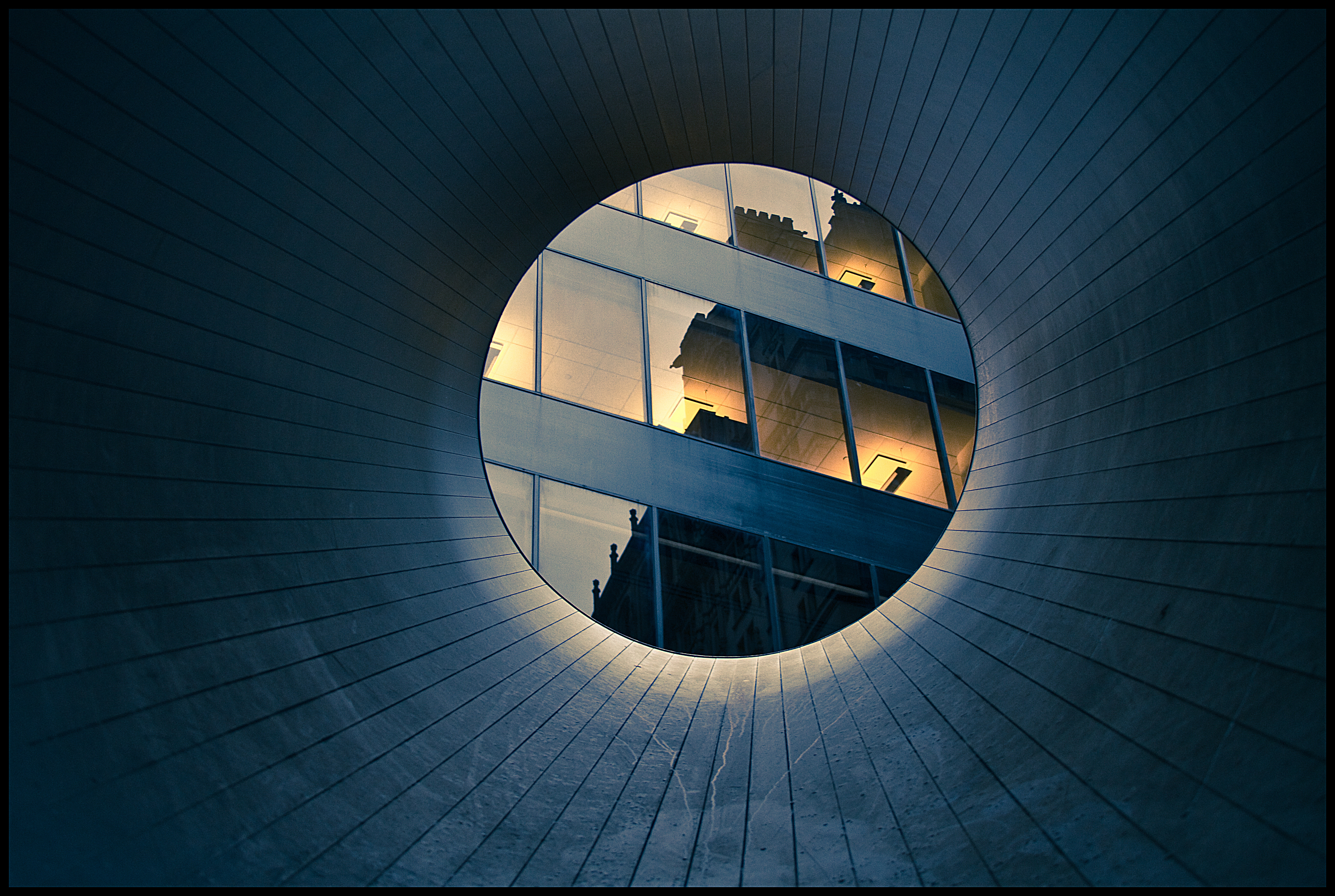 Reflection on high rise building windows through a tube