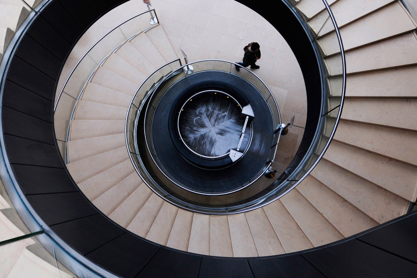 aerial view of spiral staircase with person at bottom