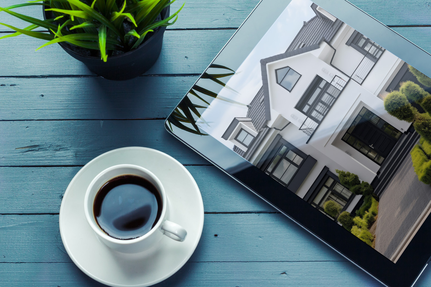 Coffee and Image of House on iPad