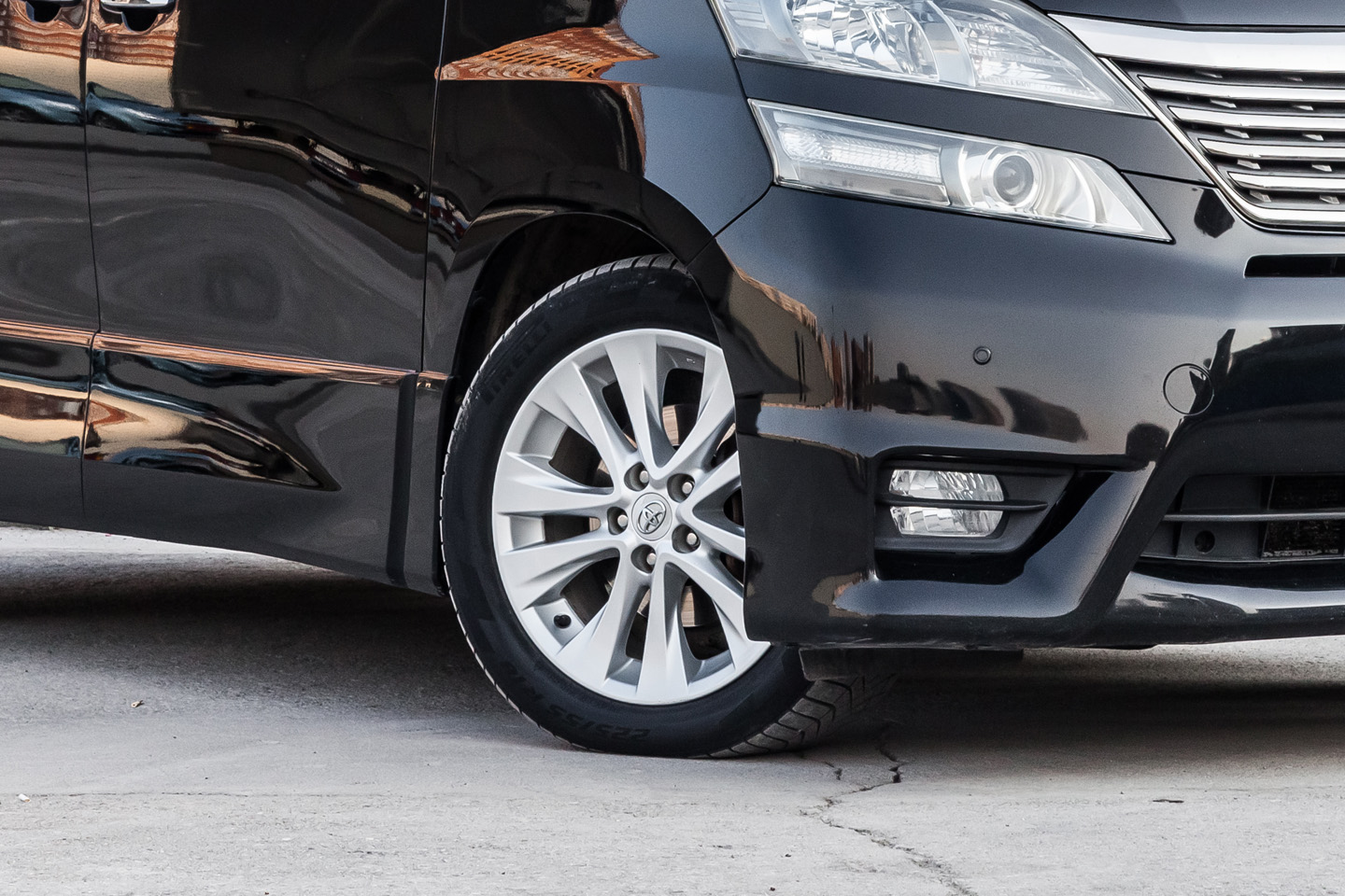 close up of car with wheel and headlight
