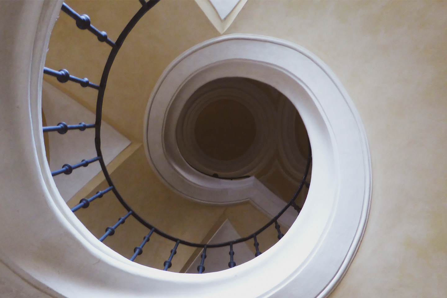 picture from beneath spiral staircase within a old house